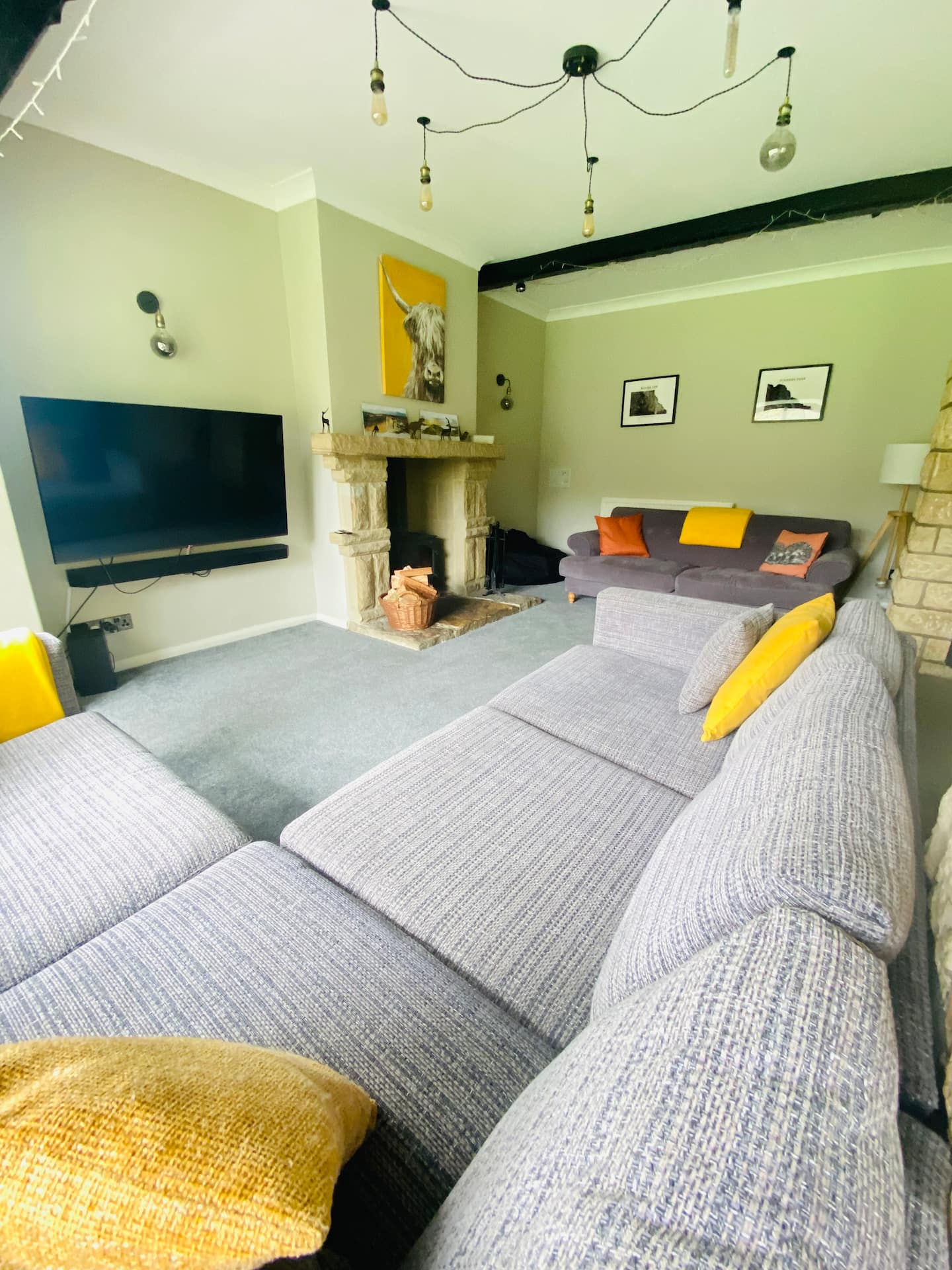 Cosy living room interior with warm lighting, wood burner glowing